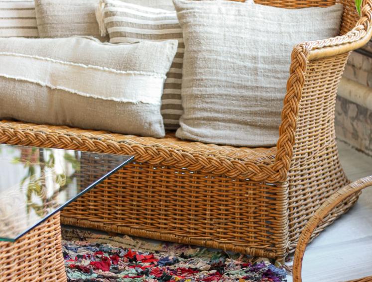 Rattan garden furniture with cream cushions