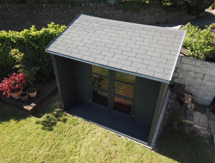 Grey BARDOLINE roof shingles on grey shed in garden