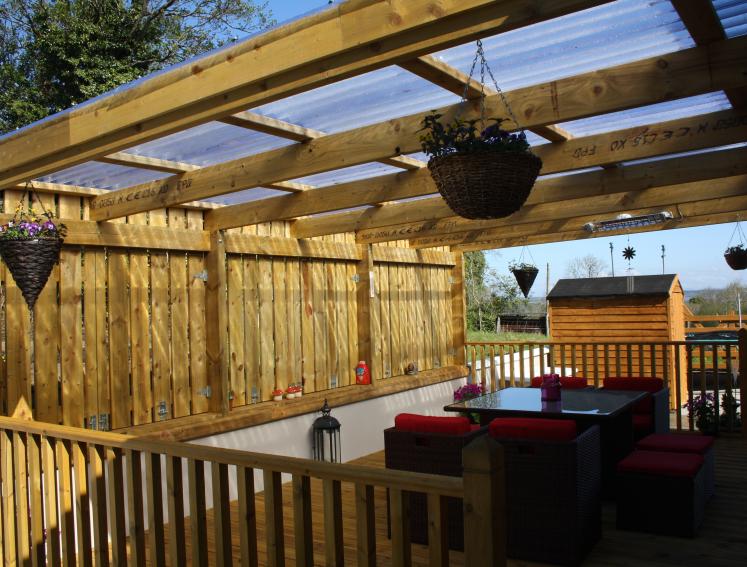 Outdoor dining area made from Onduline clear roofing sheets