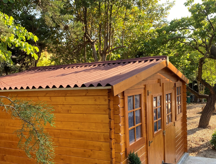 Shed with ONDULINE CLASSIC roof sheets surrounded by trees