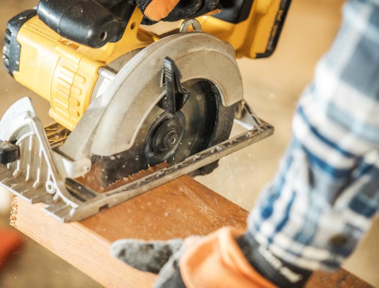 A power saw cutting timber