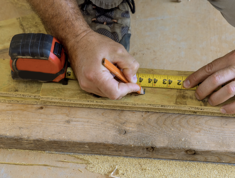 Man measuring out timber