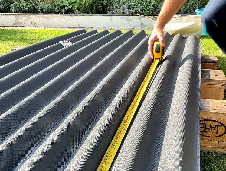 A man measuring out ONDULINE CLASSIC roofing sheets