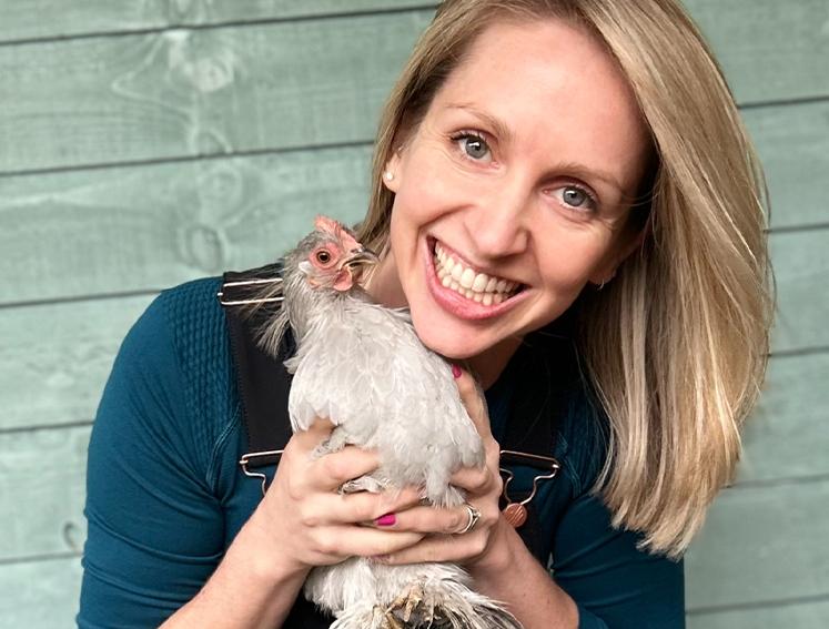 Charlotte Seaton holding one of her chicken's