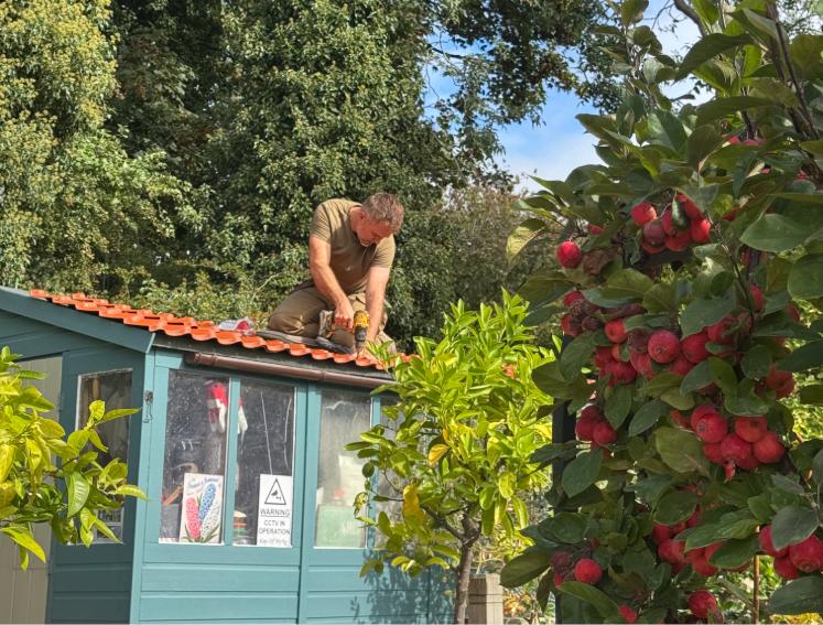 Onduline's INNOLINE roofing sheets being installed on a garden shed