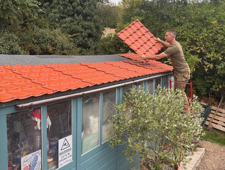 Onduline's INNOLINE roofing sheets being installed on a garden shed