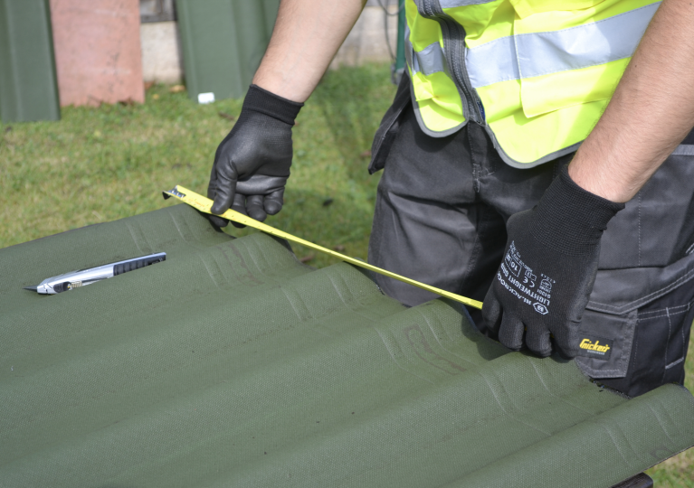 Roofing sheet being measured
