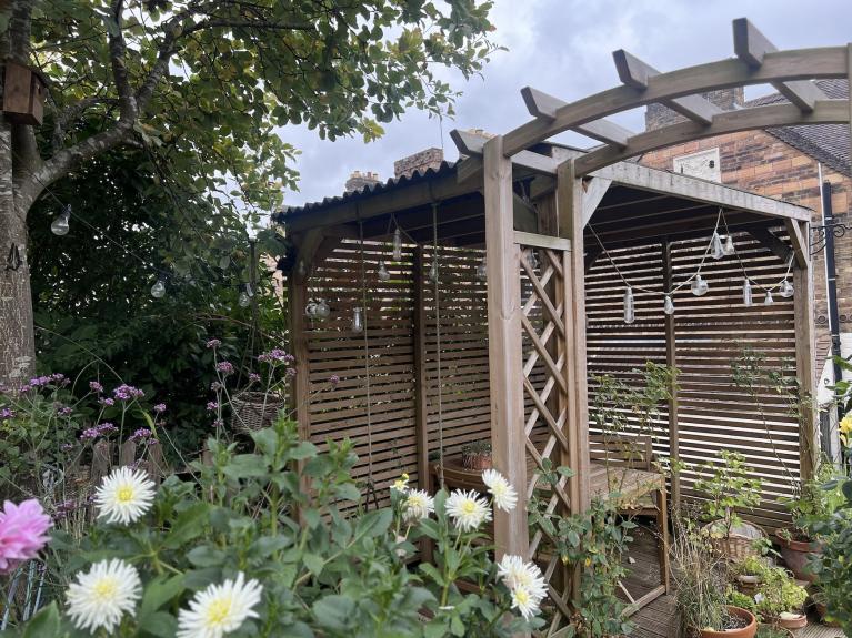 A pergola featuring Onduline roofing sheets